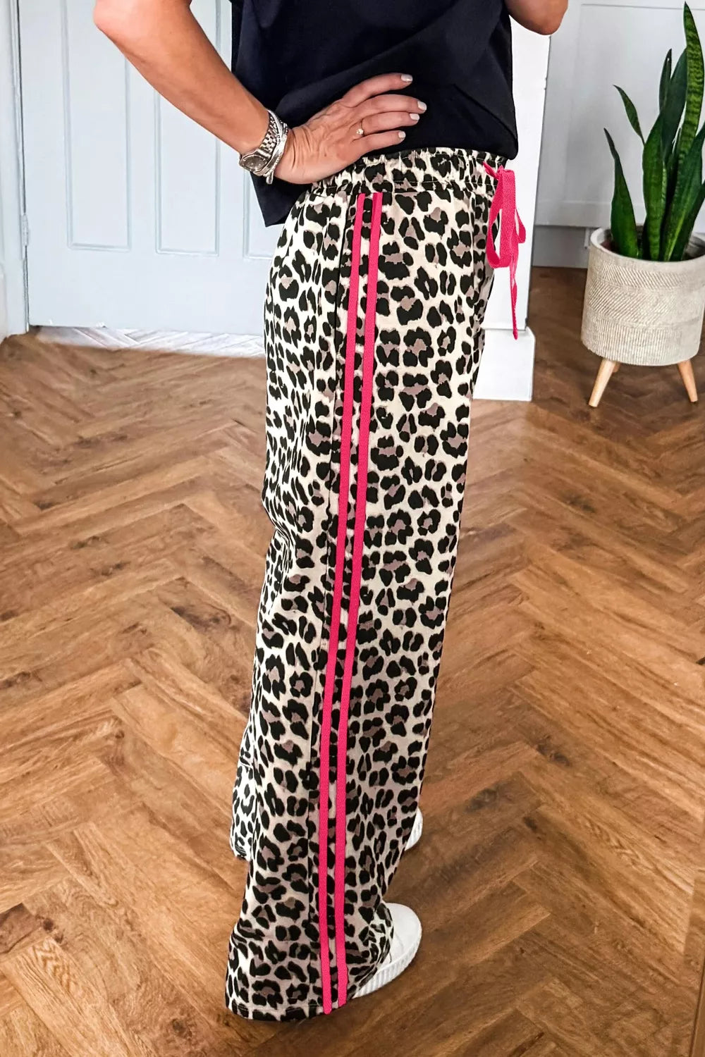 Leopard print casual pants with drawstring waist and regular fit from Plush Fashion Hub, shown on a model.