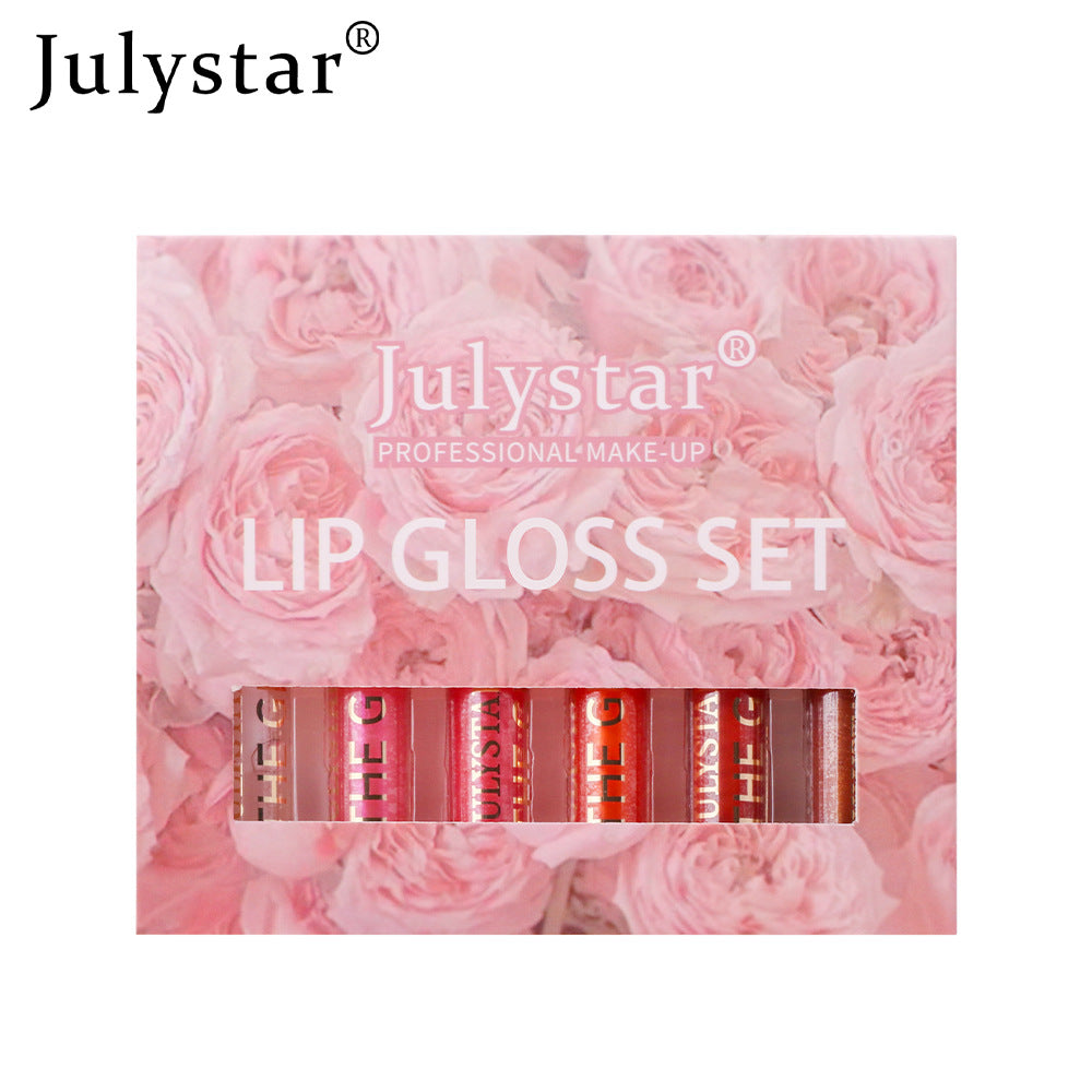 Julystar lip gloss set in a pink floral box, featuring six tubes with gold lettering.