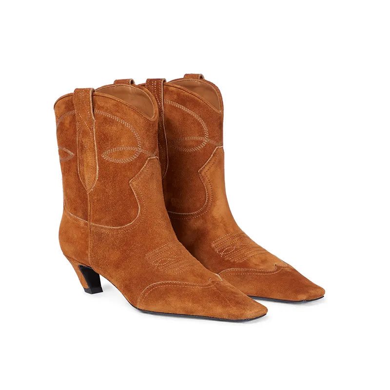 Brown suede western ankle boots featuring decorative stitching and short kitten heels.