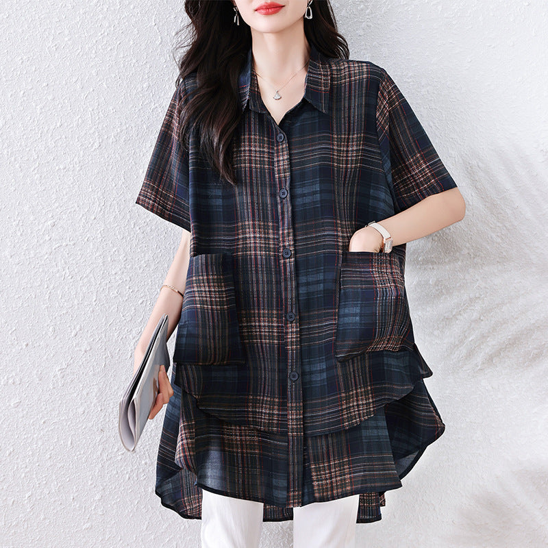 Black, brown, and blue plaid cotton short-sleeve button-down shirt with front pockets, collar, and layered hem.