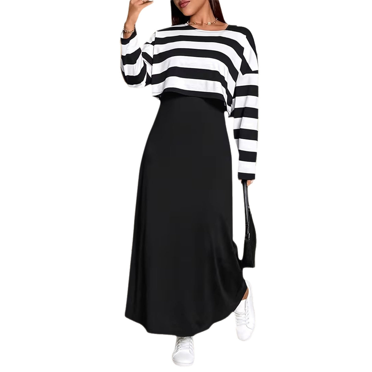 A black and white striped long-sleeve crop top paired with a solid black maxi dress.