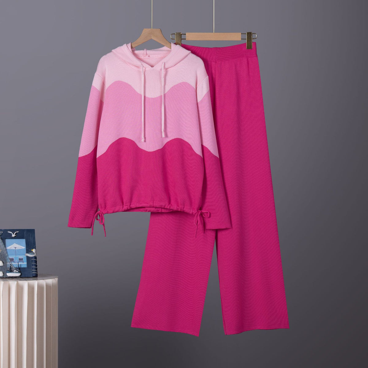 Pink knitted loungewear set with a wavy colorblock hoodie, drawstring waist pants, and casual style.