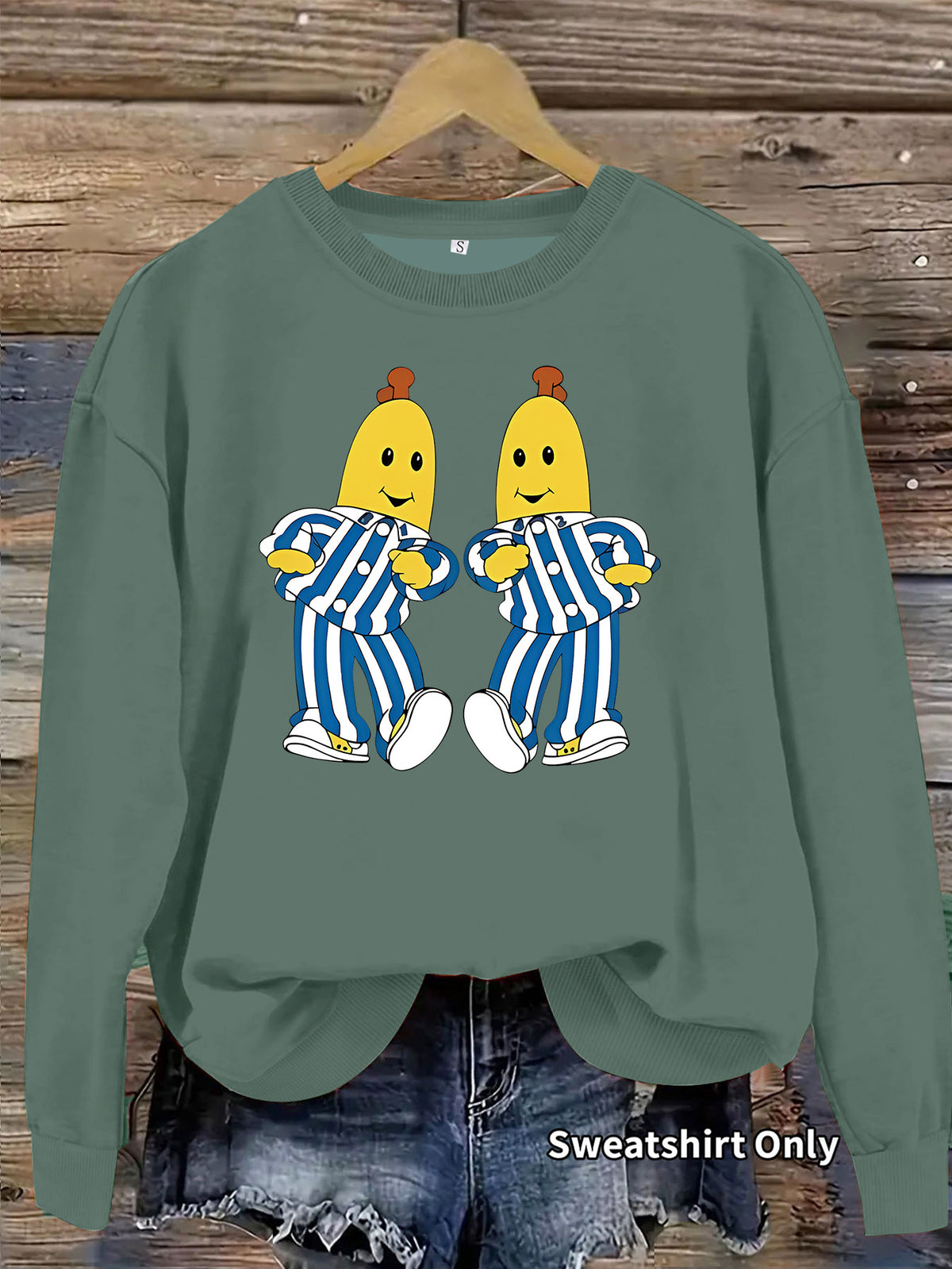 Green crewneck sweatshirt featuring a graphic of Bananas in Pyjamas on the chest.