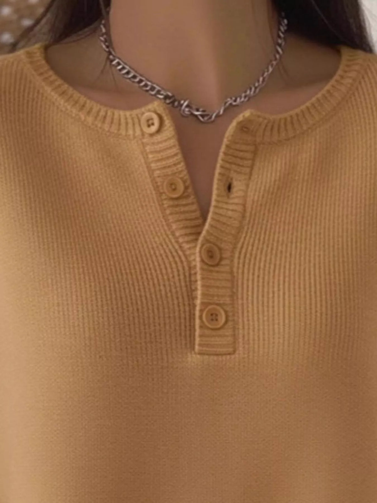 Plus size ribbed knit sweater with button details from Trendsi, featuring a cozy, full-length design and textured fabric.