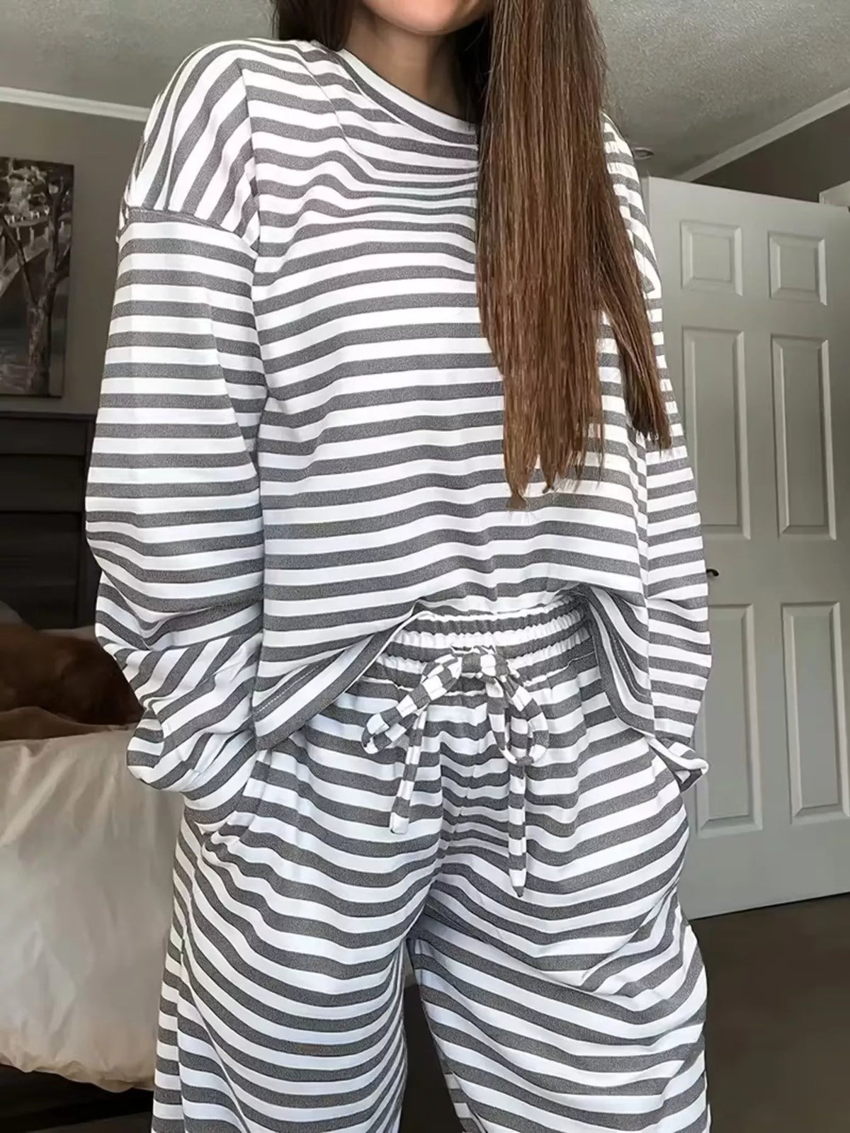 Striped dropped shoulder top and pants set by Trendsi, featuring a relaxed fit and stylish casual design.