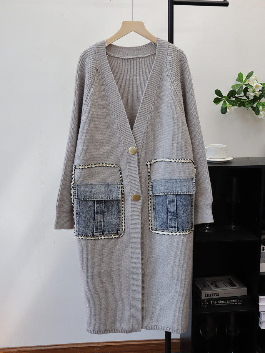 Grey knit cardigan sweater, long-sleeve, V-neck, oversized with two large denim flap pockets, button front.