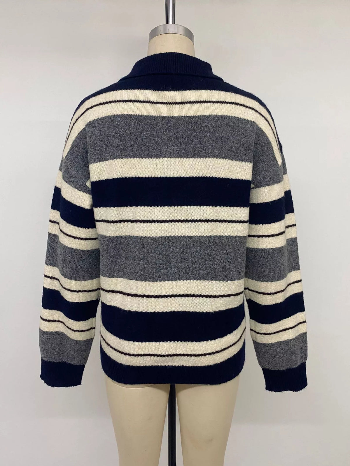Plaid long sleeve sweater with button details from Plush Fashion Hub, featuring a striped pattern and cozy knit fabric.