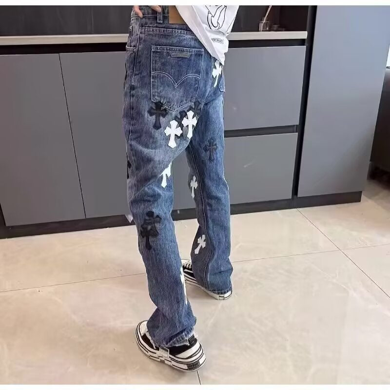 Back view of blue denim jeans with black and white cross patches, casual style with back pockets and belt loops.