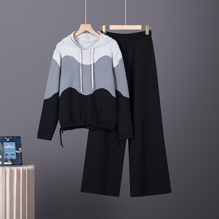 Knit hoodie and wide pants set with wavy color-block pattern in white, grey, and black, featuring drawstring hood and hem.