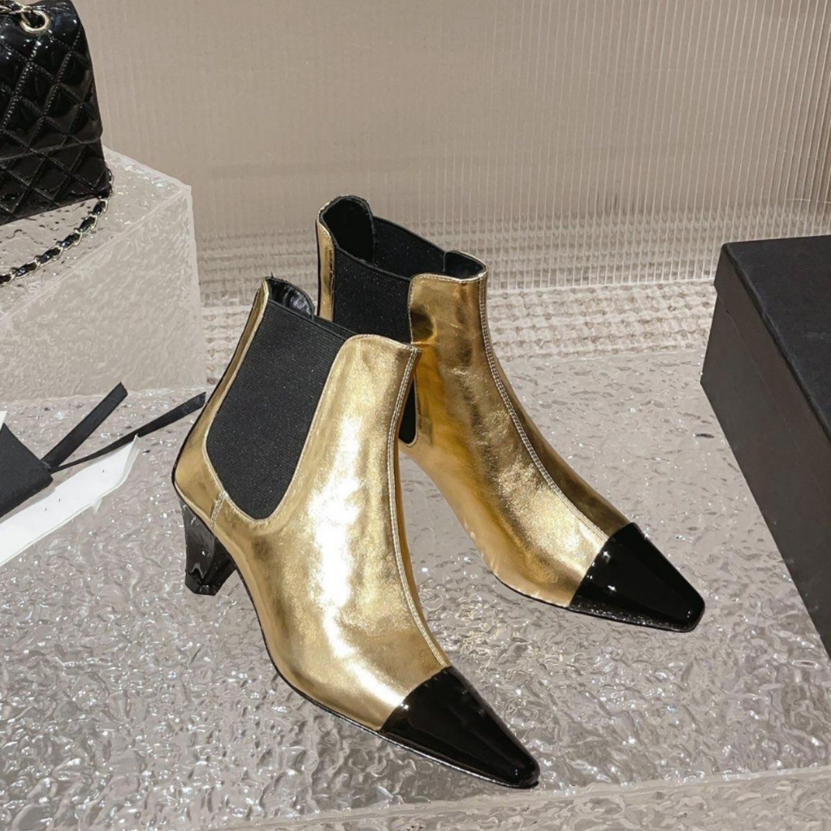Metallic gold and black patent leather ankle boots, block heel, pointed cap toe, and elastic side panels.