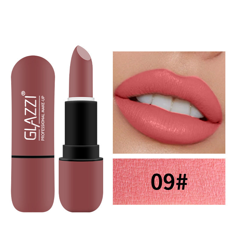 Dusty rose matte lipstick in pill-shaped case with Glazzi logo, shown on lips.