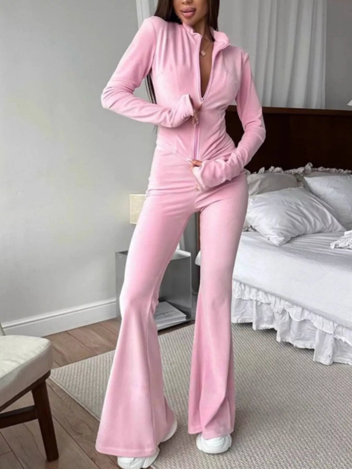 Trendsi zip-up crop top and flared pants two-piece set, featuring a fitted crop top and high-waisted flared pants in stylish fabric.