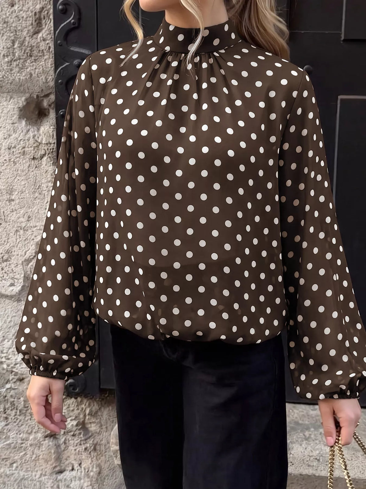 Polka dot mock neck long sleeve blouse from Trendsi featuring a stylish design and classic fit, perfect for casual or professional wear.