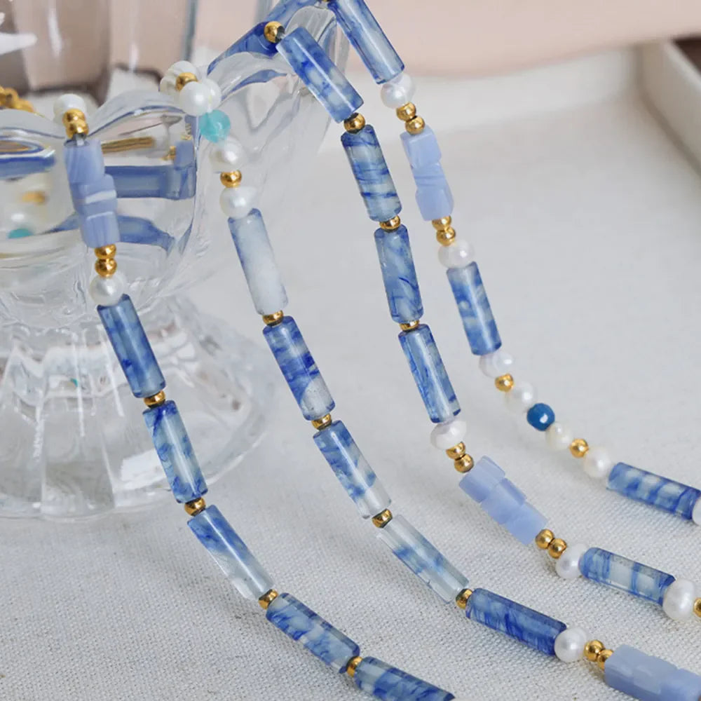 Freshwater pearl and titanium steel geometric bead necklace featuring modern design, displayed on a neutral background.