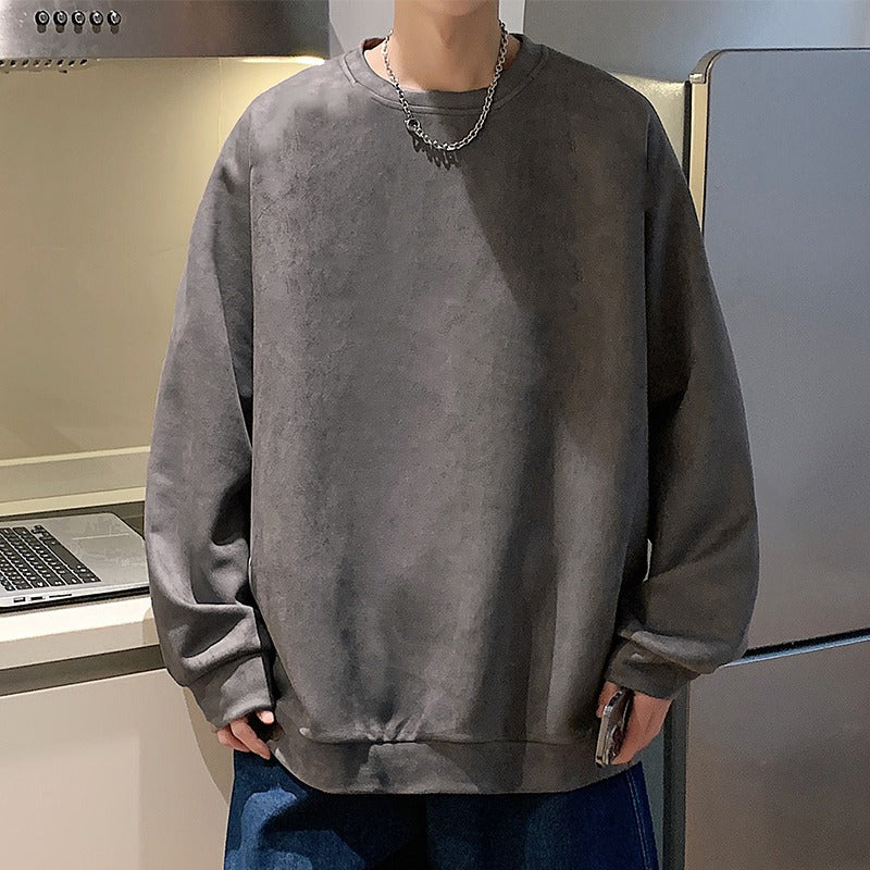 Dark grey crewneck sweatshirt in faux suede with a slouchy, oversized style and ribbed cuffs.