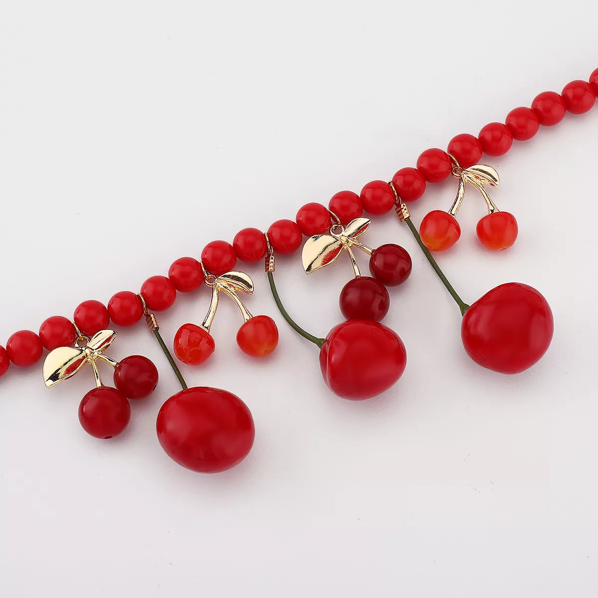 Cherry Charm beaded statement necklace by Plush Fashion Hub featuring vibrant red cherry beads and intricate beadwork.