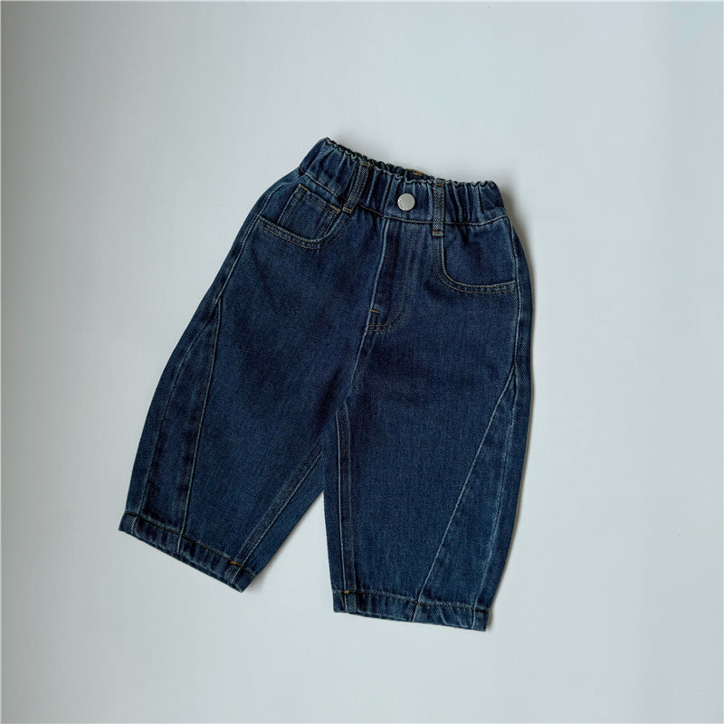 Dark blue denim pants with elastic waistband, front pockets, and curved seam details.