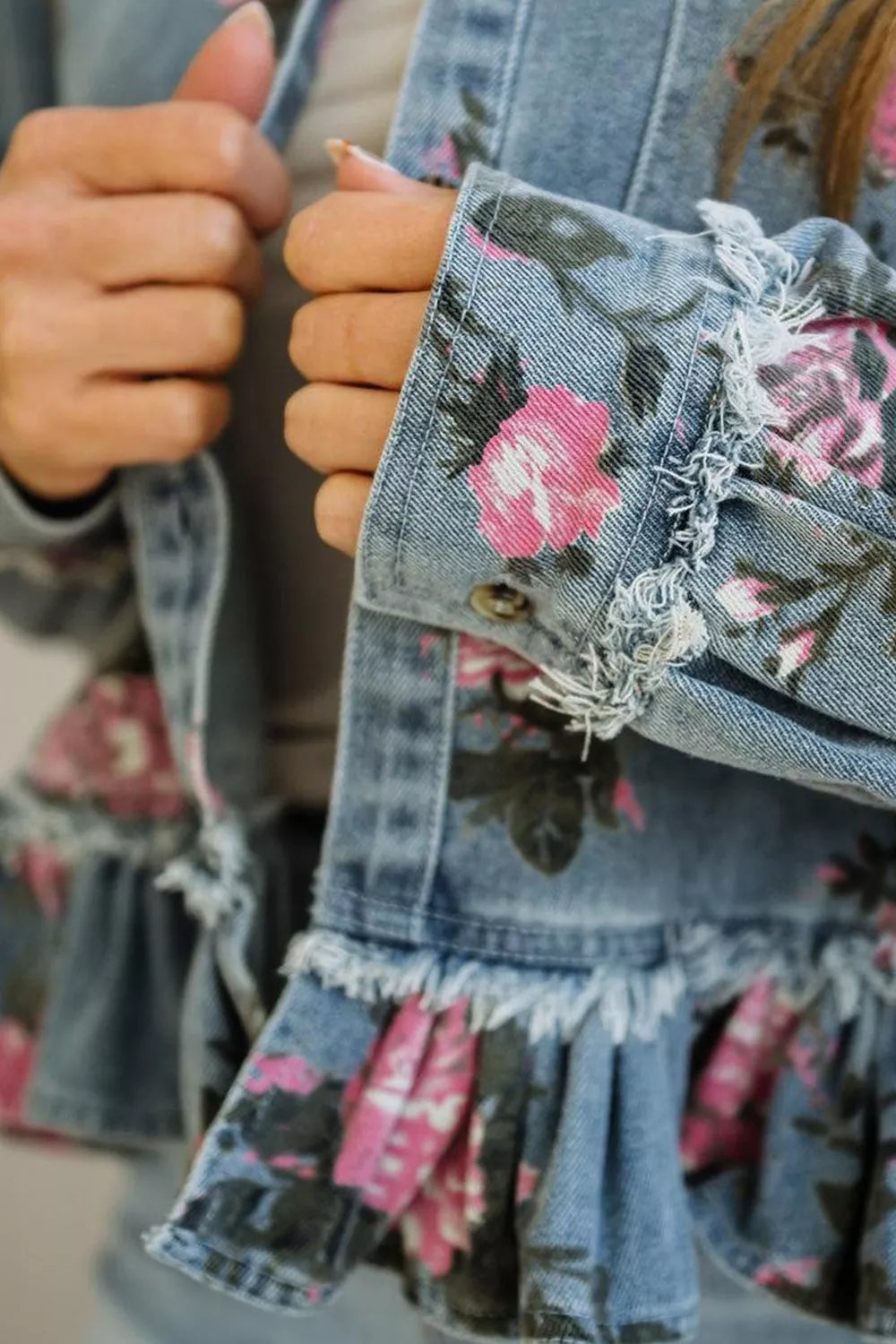 Floral print denim jacket with ruffled hem by Plush Fashion Hub, featuring colorful floral patterns and classic denim texture.