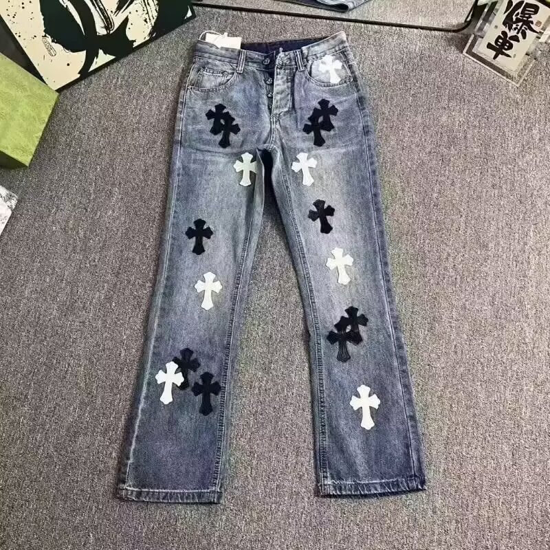 Blue denim jeans with black and white cross patches, button fly, and straight leg style.