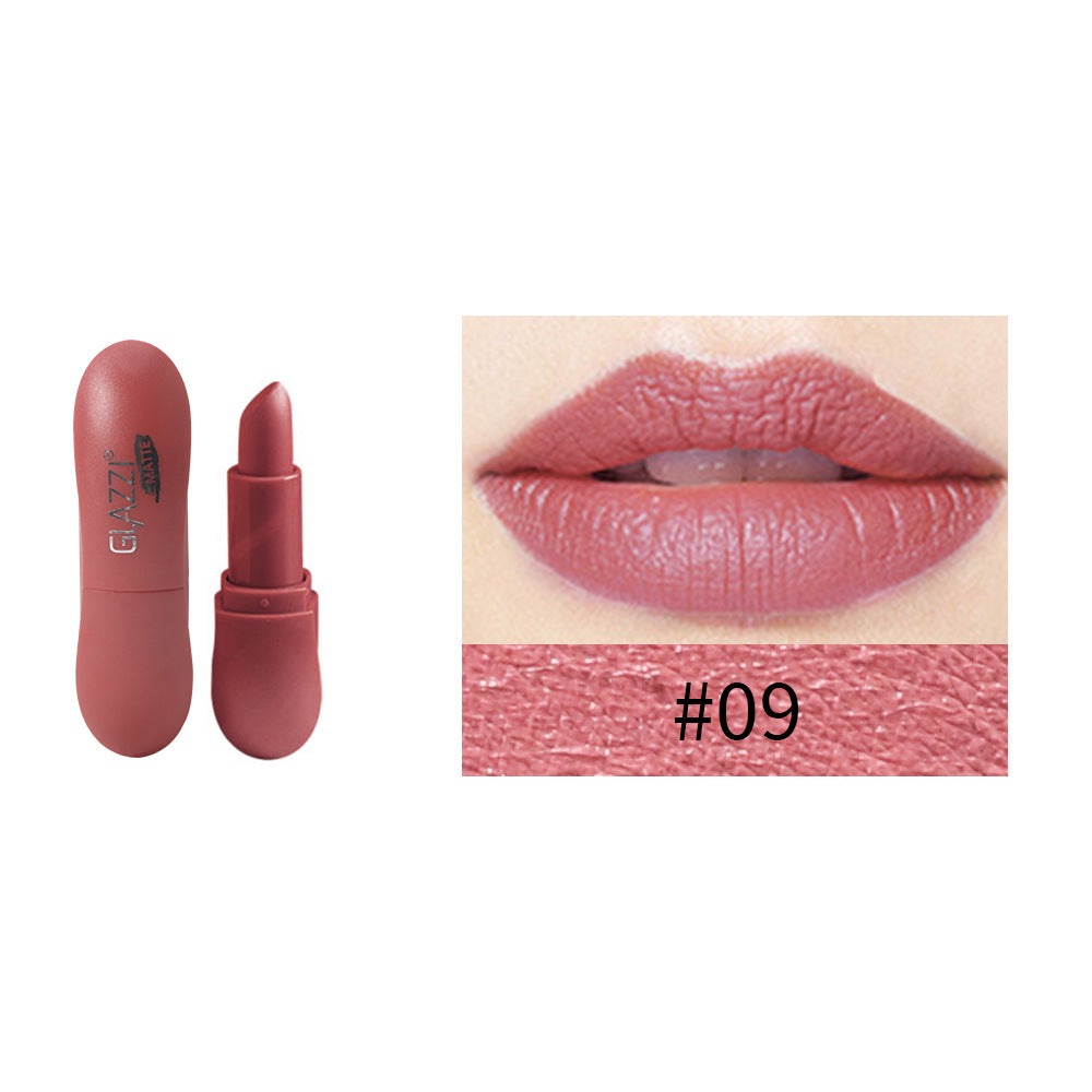 Matte dusty rose lipstick in pill-shaped case with swatch and lips wearing shade 09.