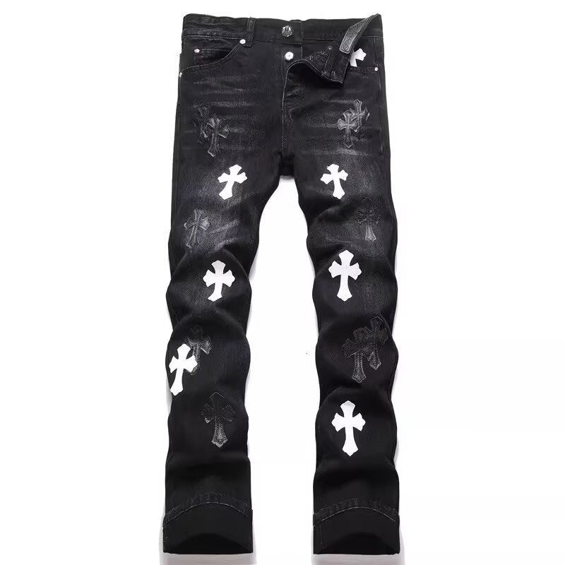 Black denim jeans with a slim-fit style, featuring white and dark cross patches and faded details.