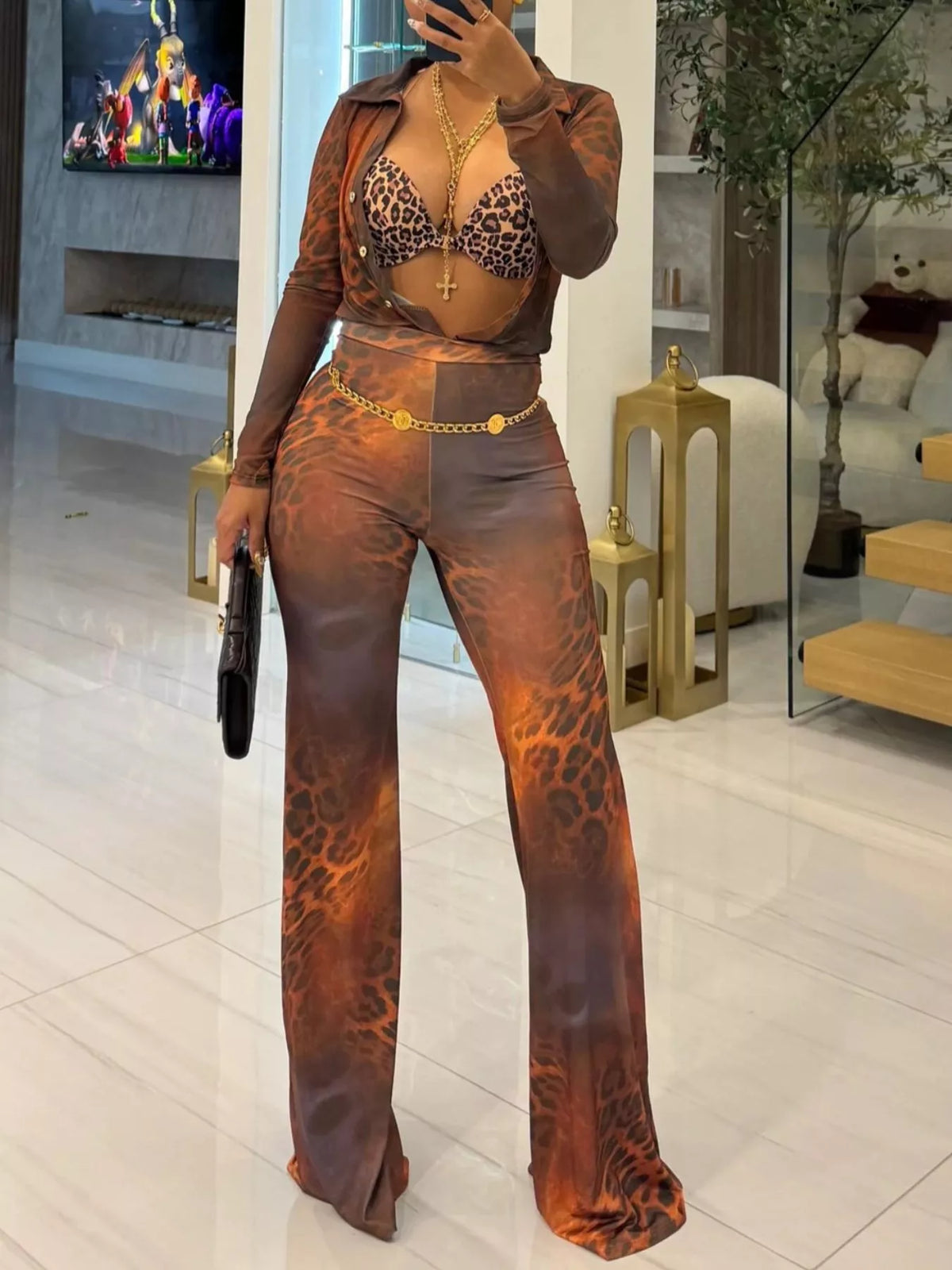 Printed mesh shirt and pants set for women by Trendsi, featuring lightweight, stylish, and breathable fabric with intricate print details.