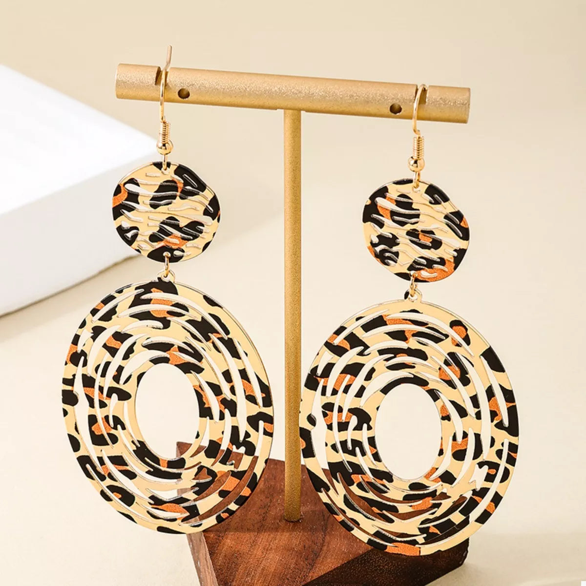 Leopard print dangle earrings from Plush Fashion Hub featuring gold hooks with leopard pattern accents.