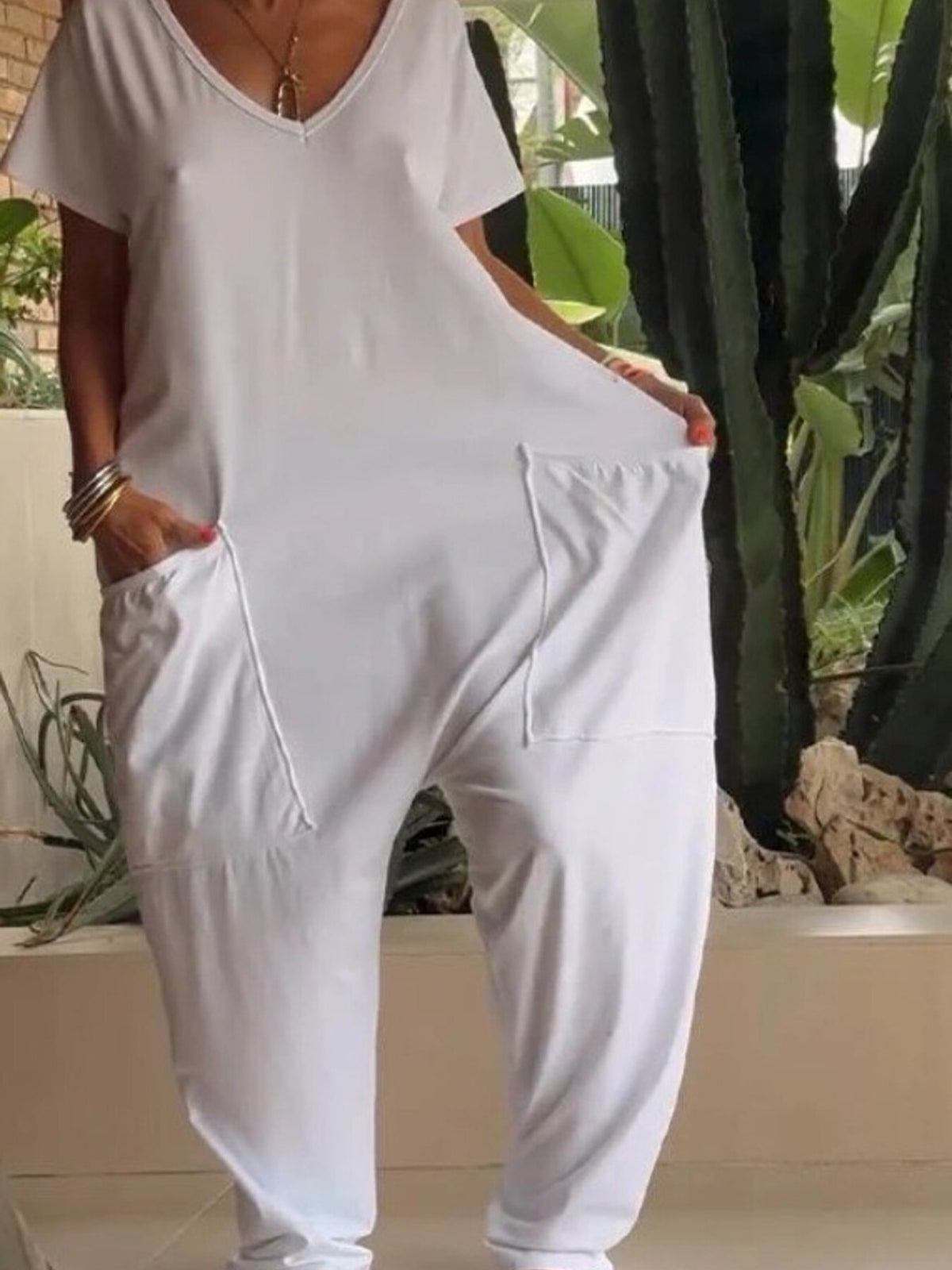 Plus size loose fit V-neck short sleeve jumpsuit with wide legs, stylish and comfortable from Trendsi.