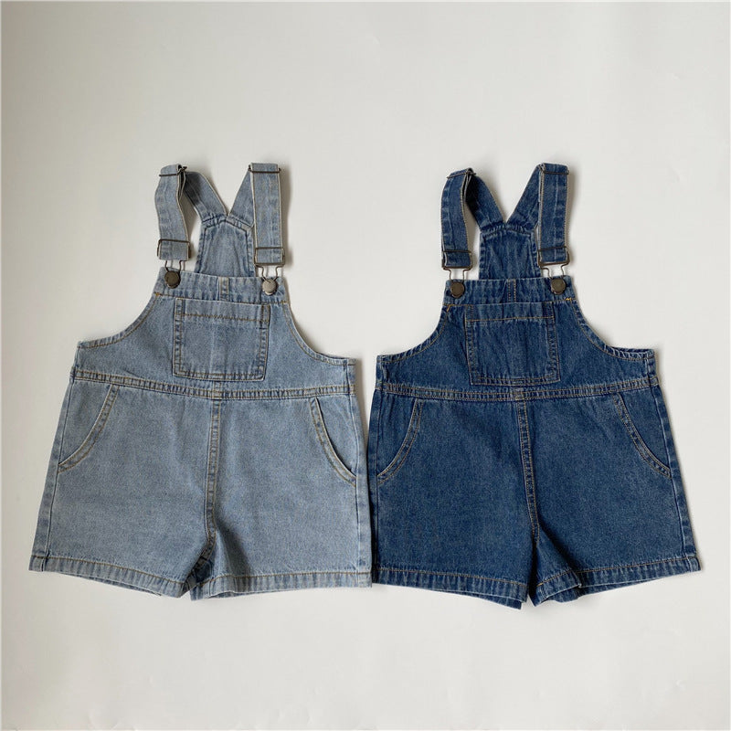 Two pairs of denim short overalls, one light blue and one dark blue, featuring front pockets, bib pockets, and metal buckles.