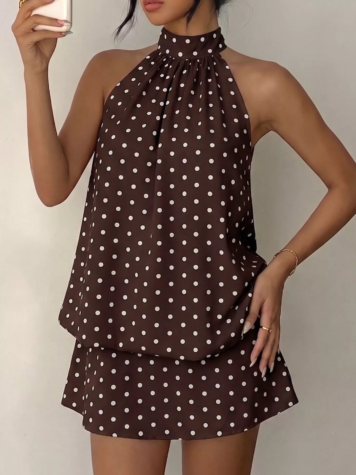 Polka dot halter neck mini dress by Plush Fashion Hub featuring a stylish design and lightweight fabric.