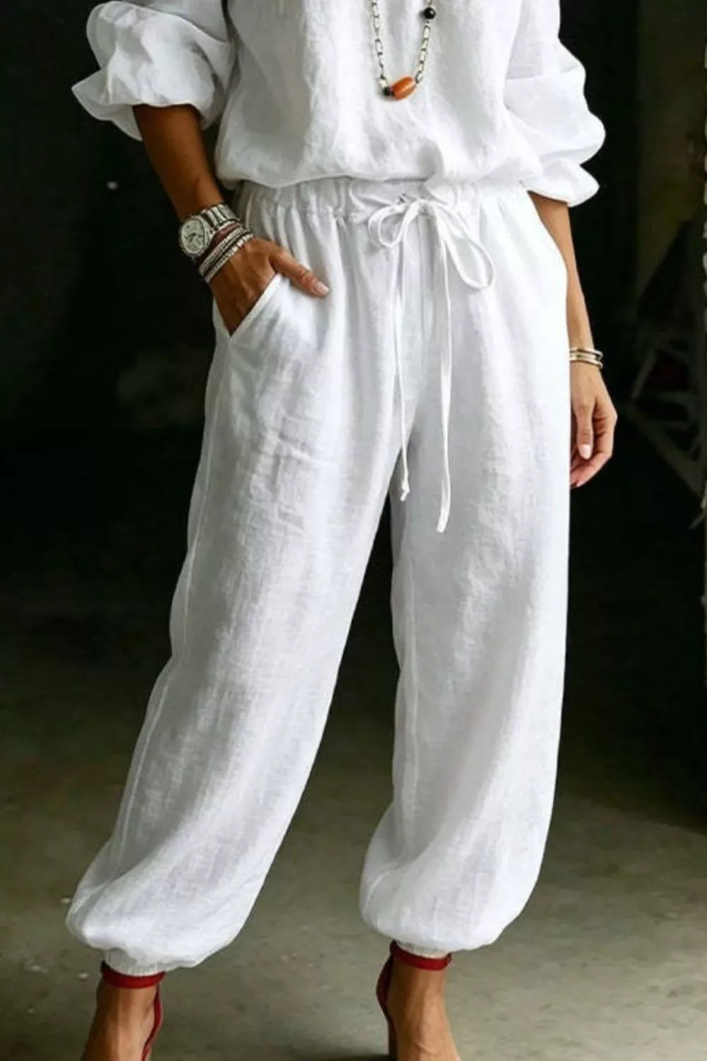 Plus size off-shoulder top and pants set by Trendsi, featuring a stylish full-length matching outfit with a relaxed fit.