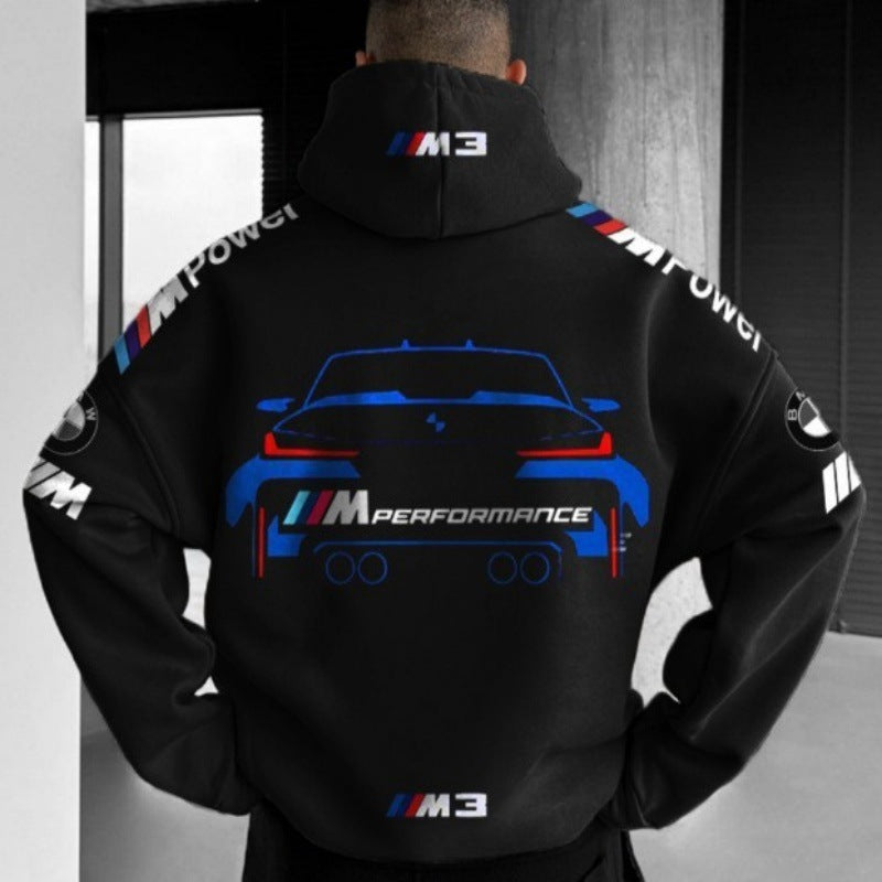 A man wearing a black long-sleeve hoodie featuring M Performance car graphics and text on the back and sleeves.