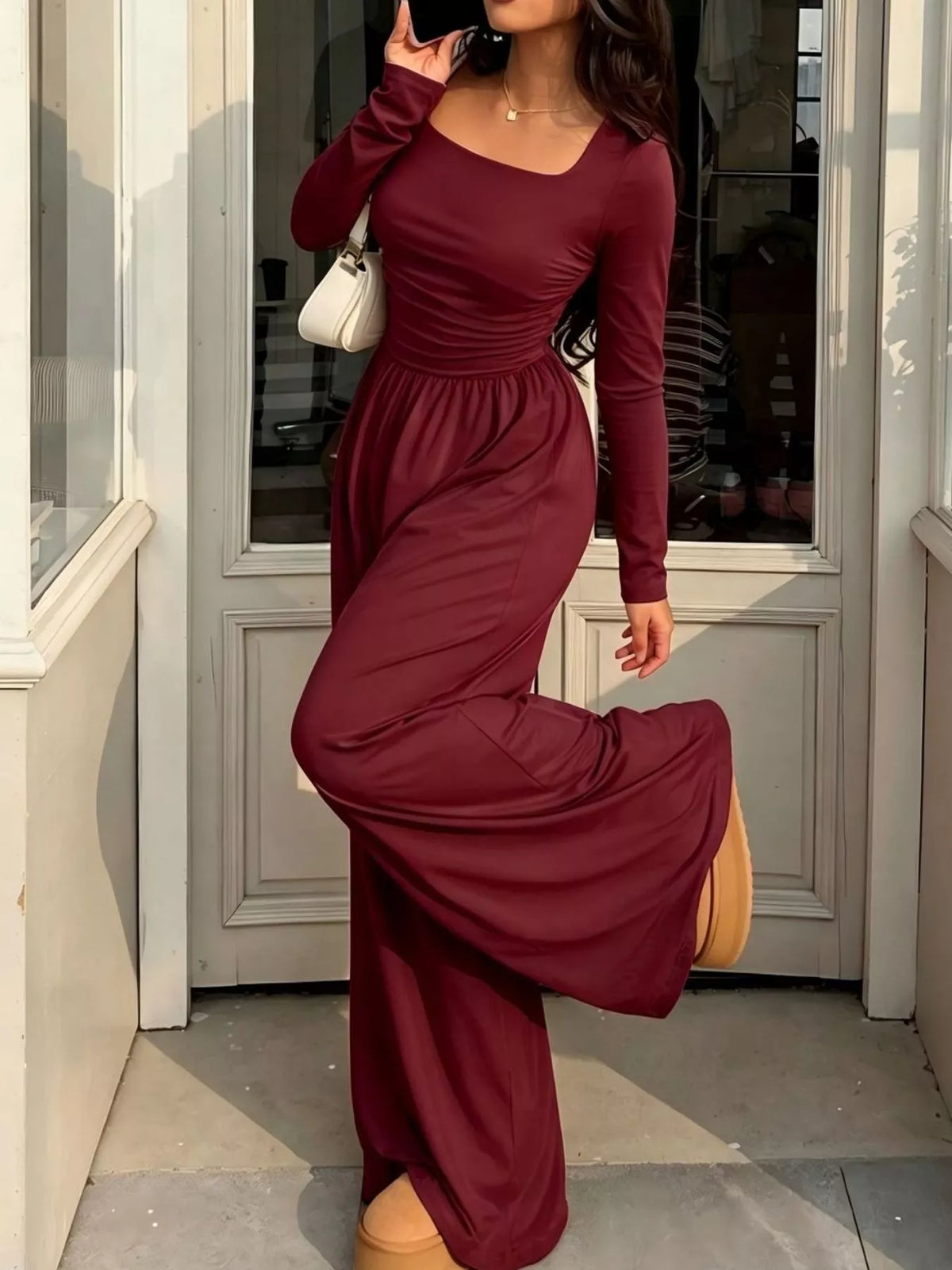 Ruched square neck wide-leg jumpsuit by Trendsi, shown in a stylish design with fitted bodice and flowing wide-leg pants.