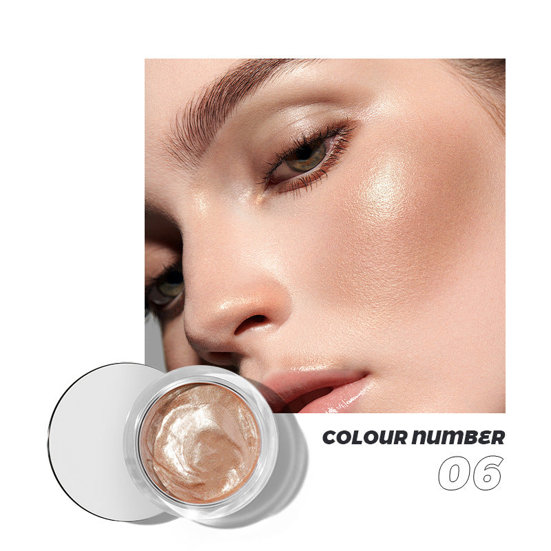 Shimmery bronze highlighter jar colour number 06, worn on a model's cheekbone, showing a glowing, metallic finish.