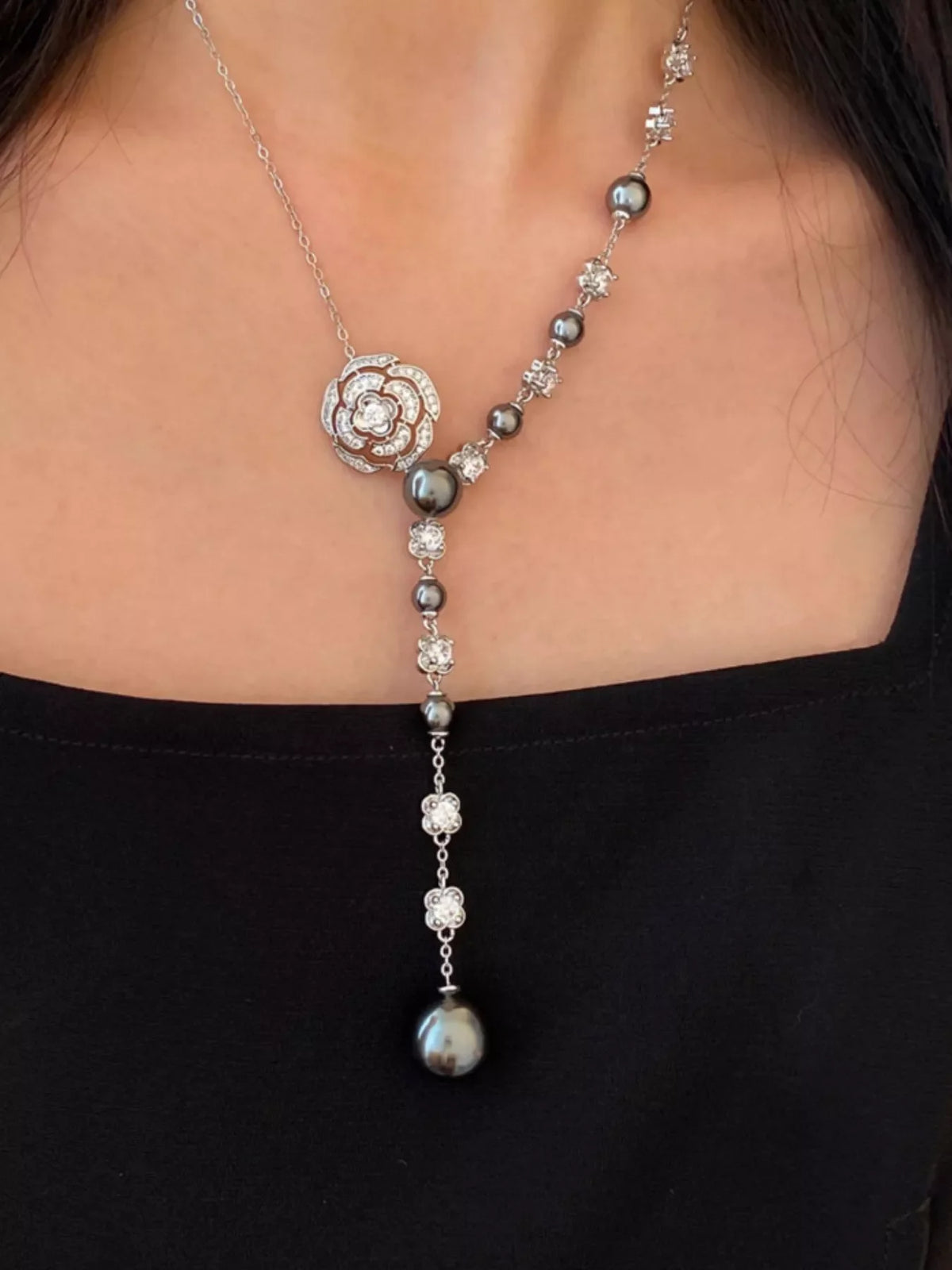 Pearl flower Y-necklace from Plush Fashion Hub featuring elegant white pearls and a floral pendant on a delicate chain
