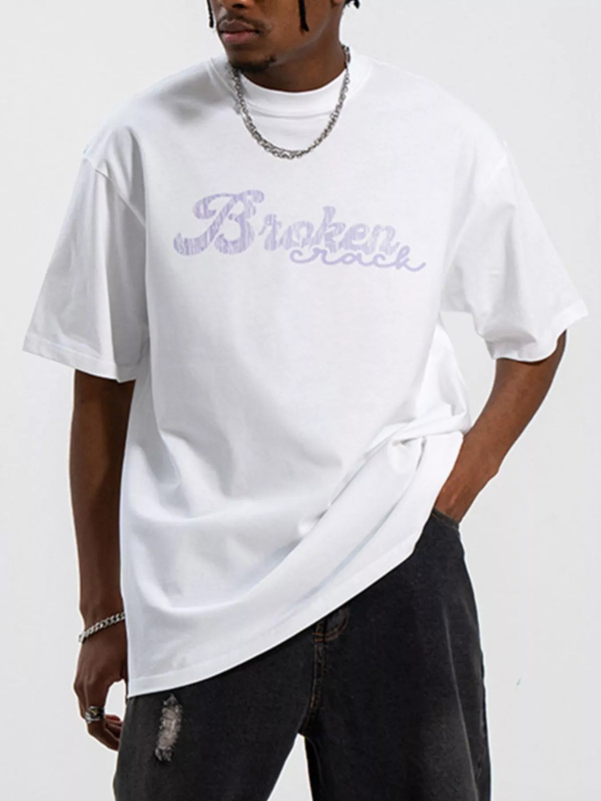 Men's oversized graphic round neck T-shirt by Trendsi, featuring bold print on soft, comfortable fabric in a relaxed fit.