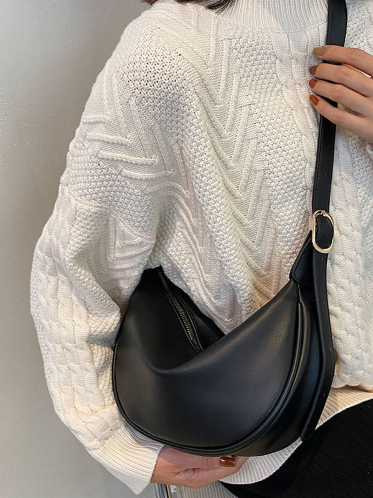 Minimalist crescent crossbody bag in smooth PU leather from Plush Fashion Hub, with sleek design and adjustable strap.