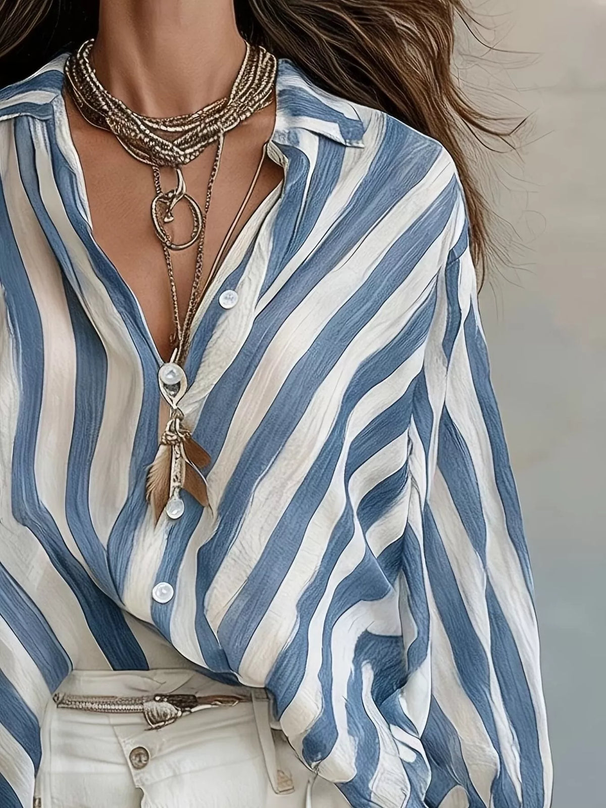 Women’s striped loose fit shirt by Trendsi, featuring a casual, relaxed design with vertical black and white stripes.