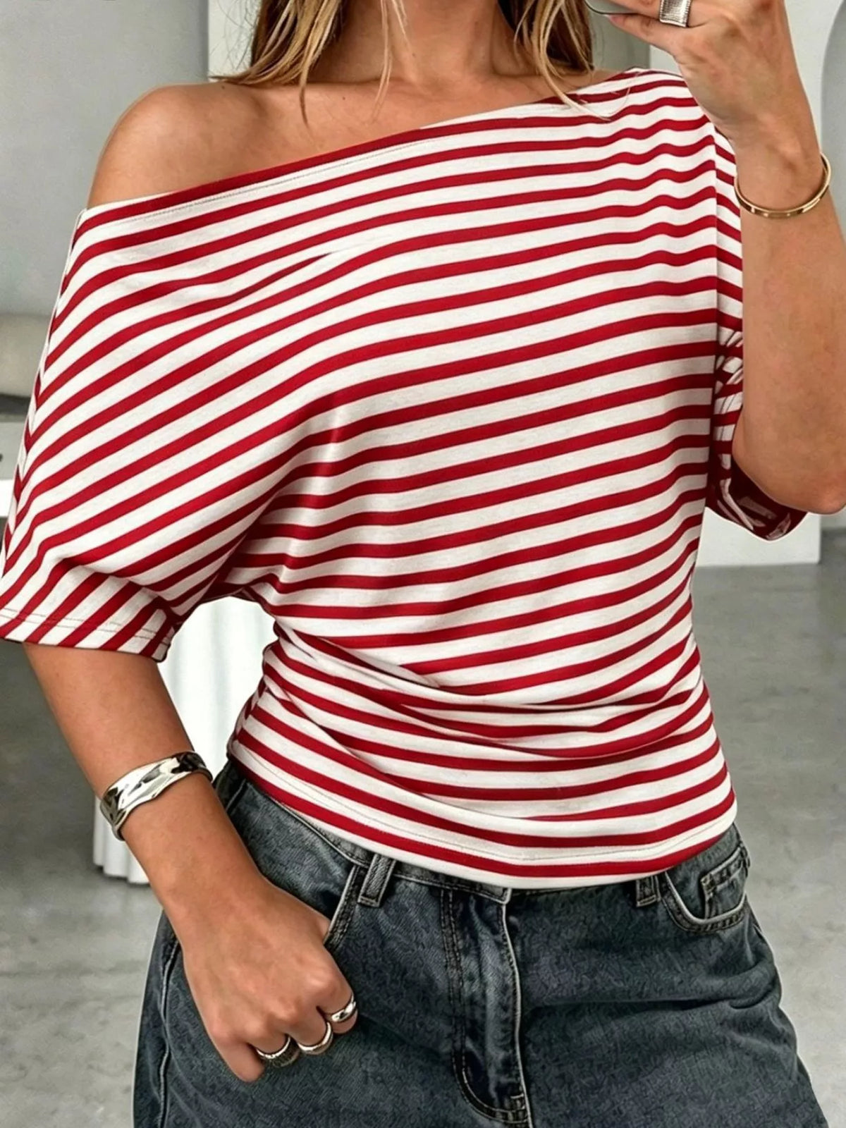 Striped one-shoulder dolman sleeve T-shirt by Plush Fashion Hub, featuring a relaxed fit and stylish design.