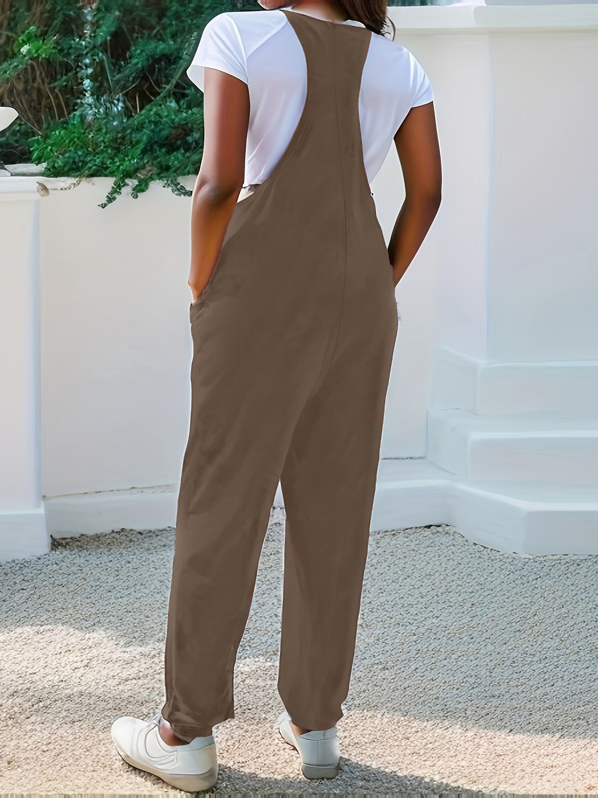 Casual loose fit spaghetti strap jumpsuit with pockets from Plush Fashion Hub, featuring a relaxed style and lightweight fabric.
