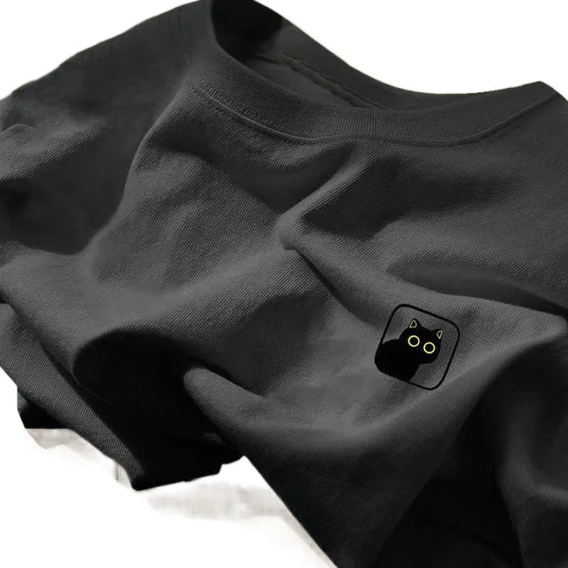 A dark gray crewneck t-shirt featuring a small black cat graphic with white eyes and ears on the chest.