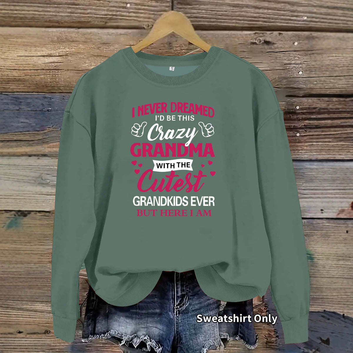 Sage green crewneck sweatshirt with pink and white text reading "Crazy Grandma with the Cutest Grandkids Ever".