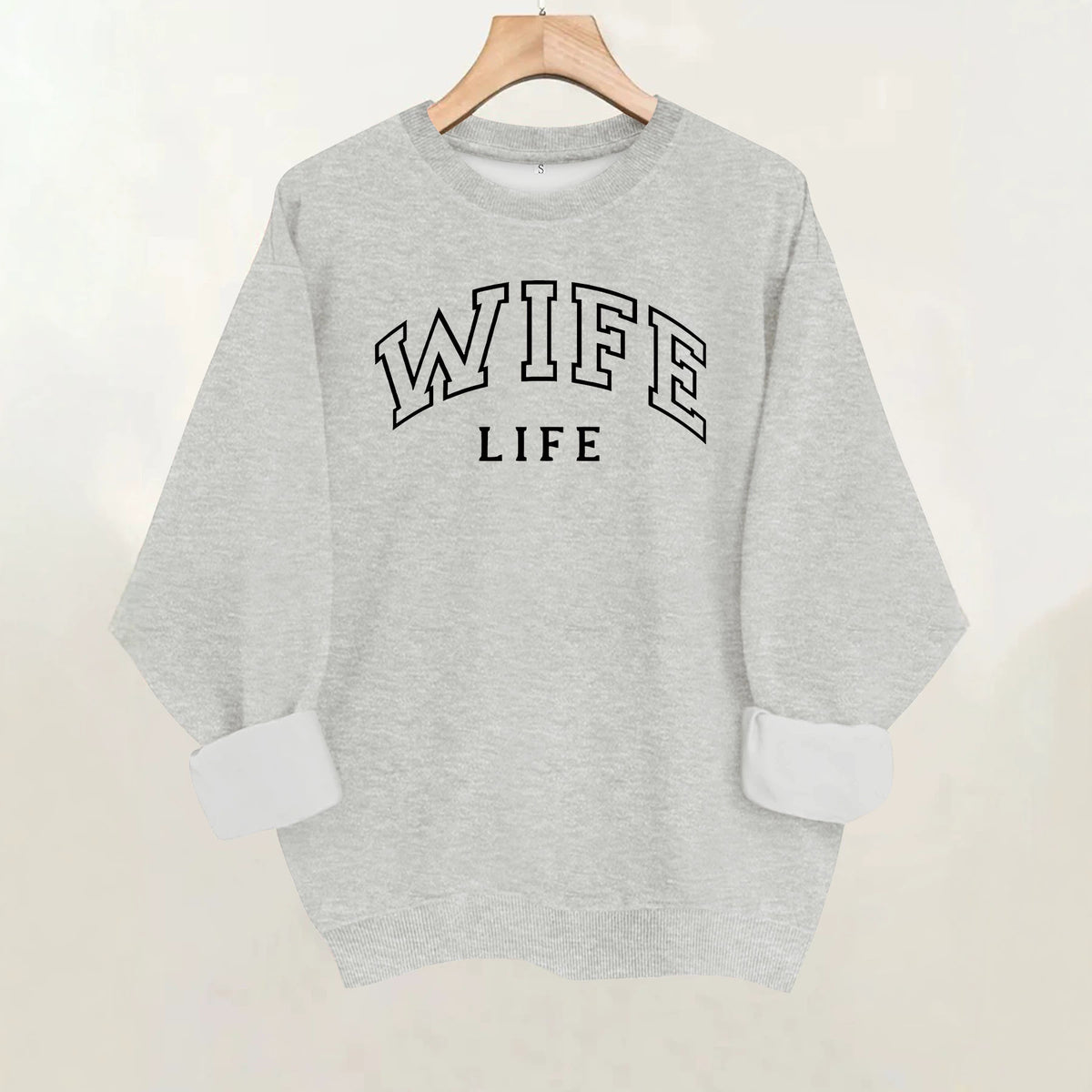 Gray knit crewneck sweatshirt with long cuffed sleeves, featuring the black text "WIFE LIFE" on the chest.