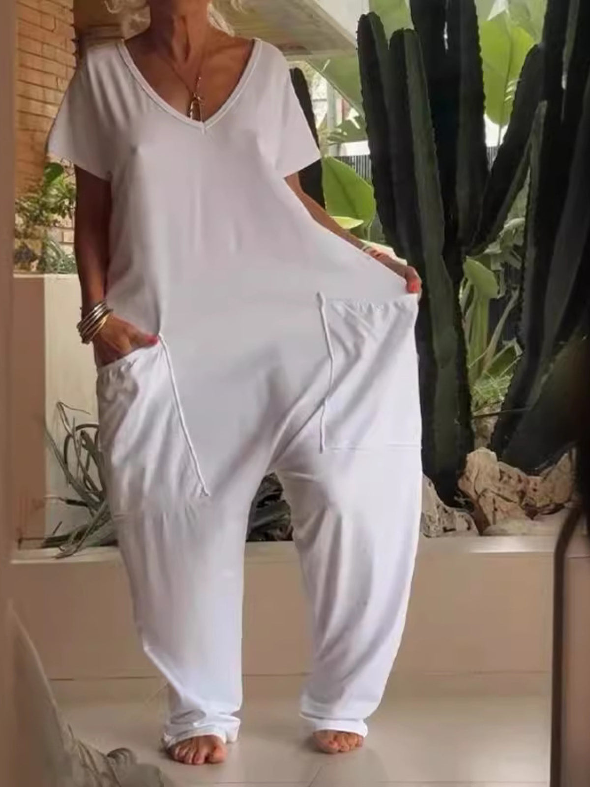 Plus size loose fit V-neck short sleeve wide leg jumpsuit by Trendsi, shown in a relaxed, comfortable fit with wide legs.