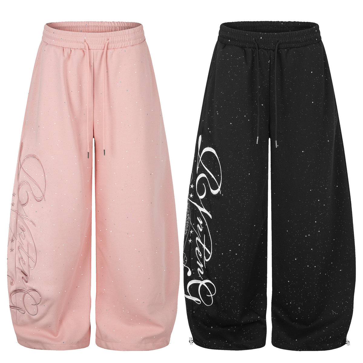 Two pairs of wide-leg sweatpants in pink and black, featuring drawstring waists and sparkly star accents.