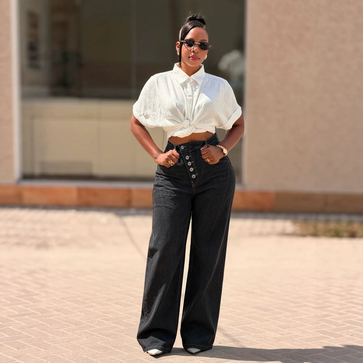 Black women's denim jeans with multi-button fly and straight-leg cut from Plush Fashion Hub, shown on a model.