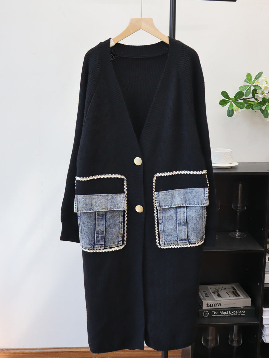 Black knit cardigan with V-neck, gold buttons, and two large denim patch pockets outlined in white stitching.