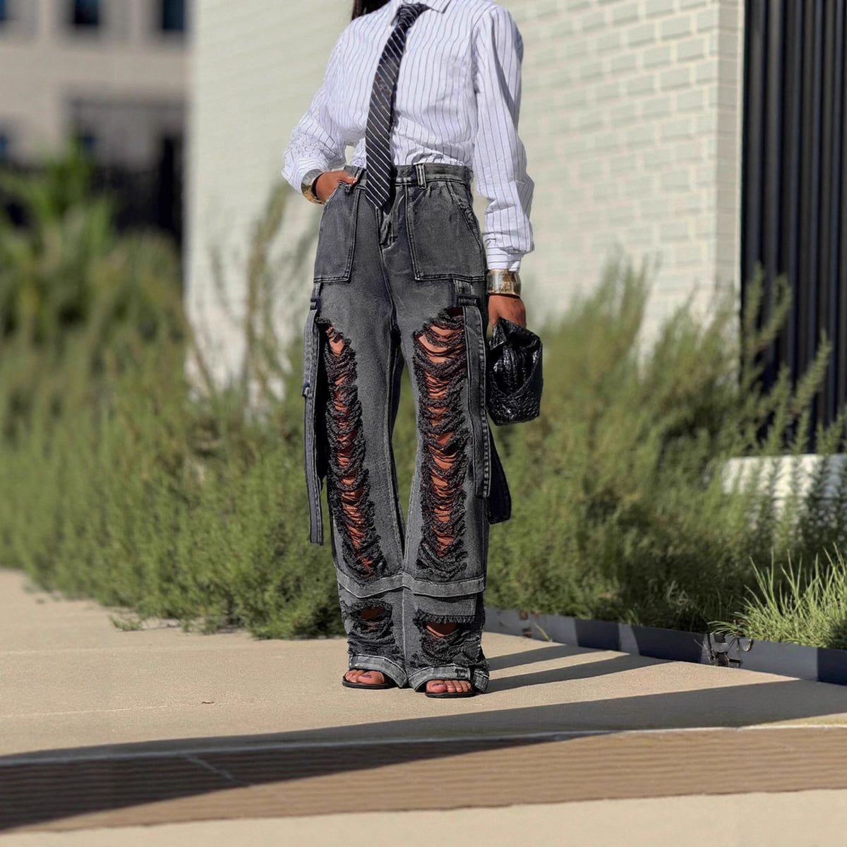 Ripped cargo jeans with tie detail in blue denim, featuring distressed knees and multiple pockets, by Plush Fashion Hub.