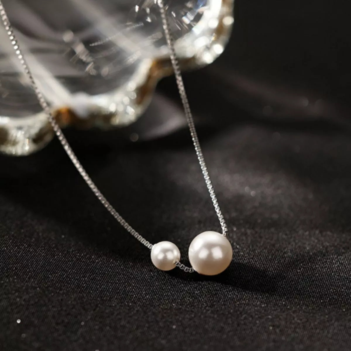 Sterling silver pearl necklace featuring a string of lustrous white pearls, designed by Plush Fashion Hub.
