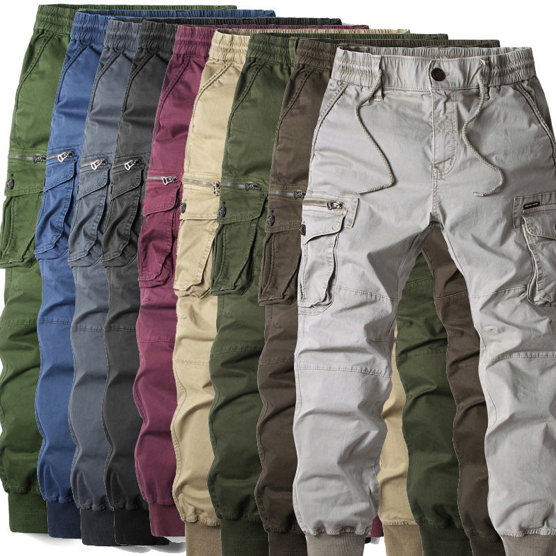 Multiple cotton cargo joggers with elastic waistbands, drawstrings, and side pockets in various solid colors.